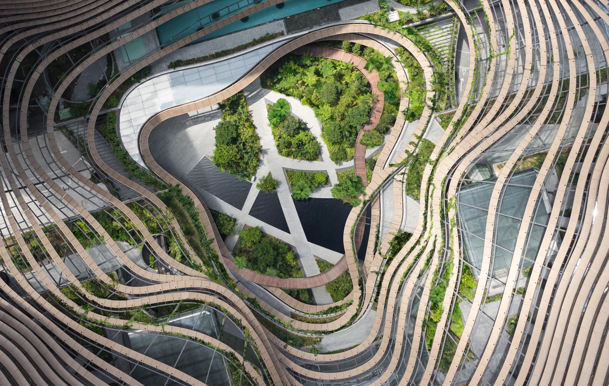 Two women sitting at a modern table talking with a city view behind them.